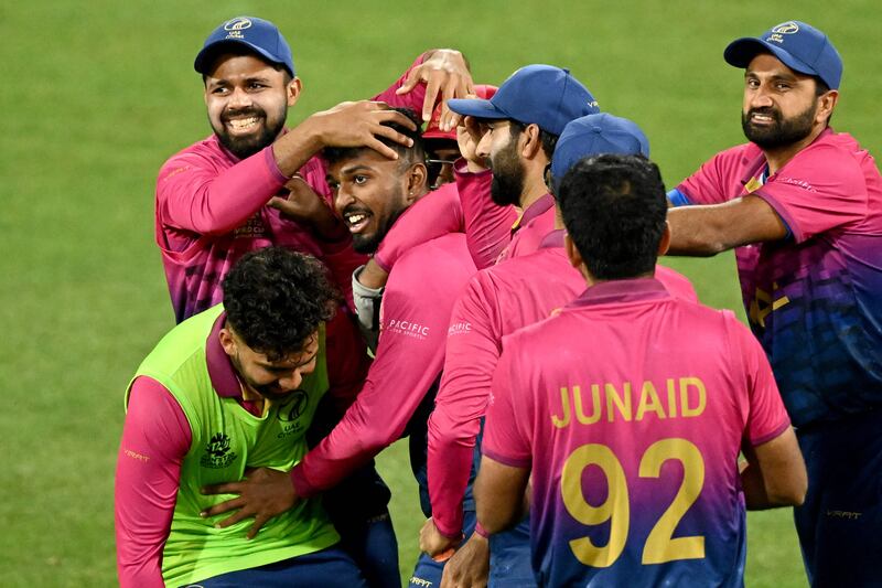 UAE's Karthik Meiyappan, centre, after his hat-trick against Sri Lanka. AFP