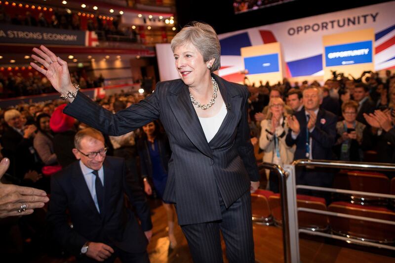 Britain's Prime Minister Theresa May greets delegates after giving her keynote address on the fourth and final day of the Conservative Party Conference 2018 at the International Convention Centre in Birmingham, central England, on October 3, 2018. May appealed on Wednesday to her divided party to unite behind her as she heads into the "toughest phase" of Brexit negotiations, as EU leaders pressure Britain to change tack. / AFP / Stefan Rousseau
