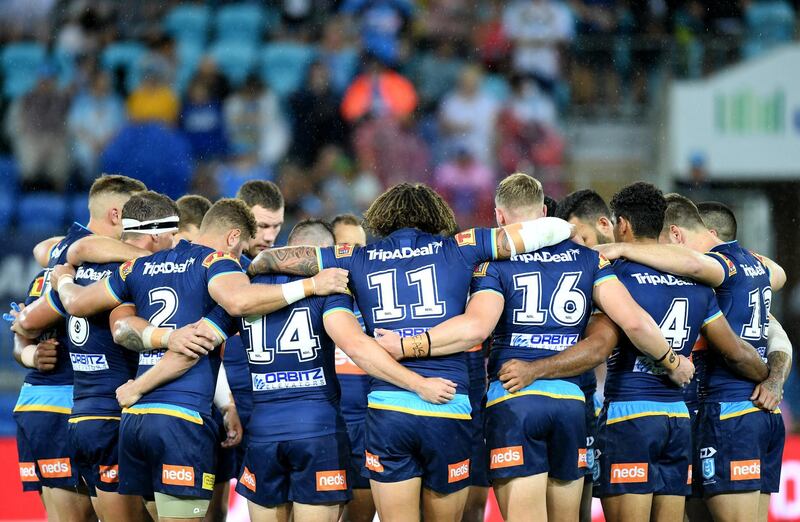 GOLD COAST, AUSTRALIA - MARCH 17: The Titans players embrace for a minutes silence in memory of 49 people who are confirmed dead, with 36 injured still in hospital following shooting attacks on two mosques in Christchurch on Friday, 15 March. 41 of the victims were killed at Al Noor mosque on Deans Avenue and seven died at Linwood mosque. Another victim died later in Christchurch hospital. A 28-year-old Australian-born man, Brenton Tarrant, appeared in Christchurch District Court on Saturday charged with murder. The attack is the worst mass shooting in New Zealand's history. During the round 1 NRL match between the Gold Coast Titans and the Canberra Raiders at Cbus Super Stadium on March 17, 2019 in Gold Coast, Australia. (Photo by Bradley Kanaris/Getty Images)