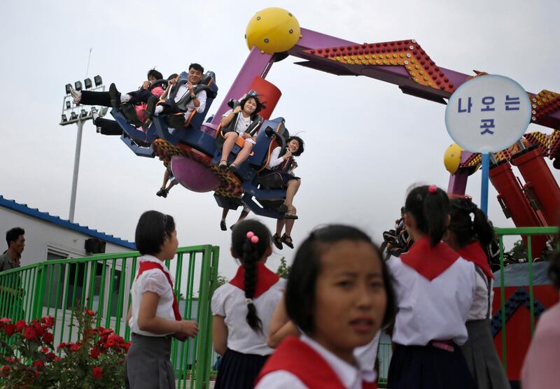 People enjoy a ride at an amusement park in Pyongyang, North Korea. Dita Alangkara / AP Photo