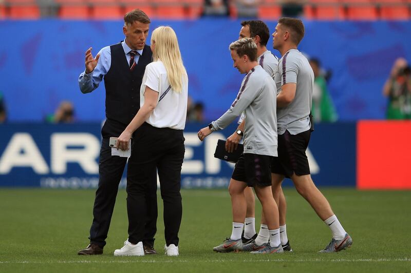 VALENCIENNES, FRANCE - JUNE 23: England Head Coach Phil Neville 
 speaks to a member of his team after  the 2019 FIFA Women's World Cup France Round Of 16 match between England and Cameroon at Stade du Hainaut on June 23, 2019 in Valenciennes, France. (Photo by Marc Atkins/Getty Images)