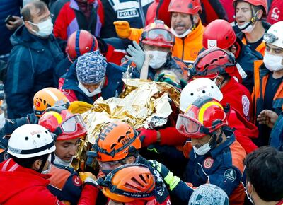 A handout picture taken and released on November 2, 2020 by Istanbul fire department shows Elif Perincek, a three-year-old survivor, holding the thumb of a rescue worker as she is carried out of a collapsed building after an earthquake in the Aegean port city of Izmir. Rescue workers were searching eight buildings in Izmir despite dwindling hope for survivors, as the death toll of a powerful magnitude earthquake which hit western Turkey rose to 69. The 7.0-magnitude quake has also injured 896 in Turkey, the Turkish emergency authority AFAD said, after striking on October 30, afternoon near the west coast town of Seferihisar in Izmir province.
 - RESTRICTED TO EDITORIAL USE - MANDATORY CREDIT "AFP PHOTO /ISTANBUL FIRE DEPARTMENT/SERKAN OKTAR " - NO MARKETING - NO ADVERTISING CAMPAIGNS - DISTRIBUTED AS A SERVICE TO CLIENTS
 / AFP / ISTANBUL FIRE DEPARTMENT / Serkan OKTAR / RESTRICTED TO EDITORIAL USE - MANDATORY CREDIT "AFP PHOTO /ISTANBUL FIRE DEPARTMENT/SERKAN OKTAR " - NO MARKETING - NO ADVERTISING CAMPAIGNS - DISTRIBUTED AS A SERVICE TO CLIENTS
