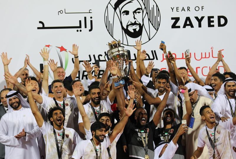 Al-Wahda FC players celebrate as they lift the trophy after beating Al Ain FC in the United Arab Emirates Super Cup. Reuters