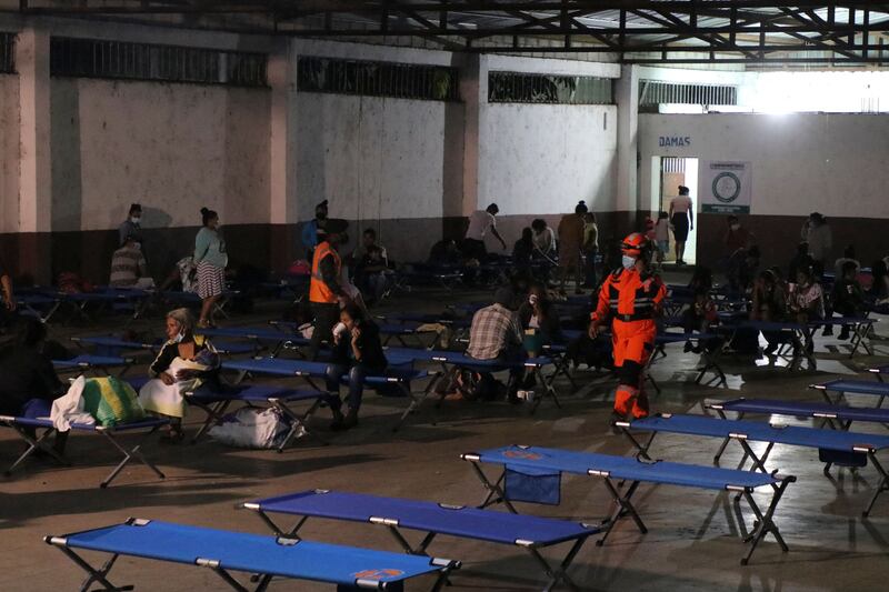 Handout picture released by Bomberos Volutarios shows Firefighters help evacuees settle in a temporary shelter in Santa Lucia Cotzumalguapa south Guatemala City. Some 370 people from a community based at the base of the Fuego volcano, in southwestern Guatemala, were evacuated on Monday following the increase in the volcanic activity of the colossus, the Civil Protection Agency reported.  AFP