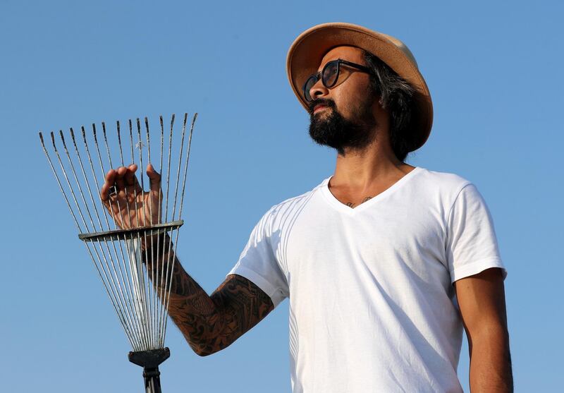 Dubai, United Arab Emirates - Reporter: N/A. Features. Sand artist Nathaniel Alapide draws murals on the beach using a rake in Jebel Ali. Tuesday, November 3rd, 2020. Dubai. Chris Whiteoak / The National

Please don't use for a standalone planned feature for early December