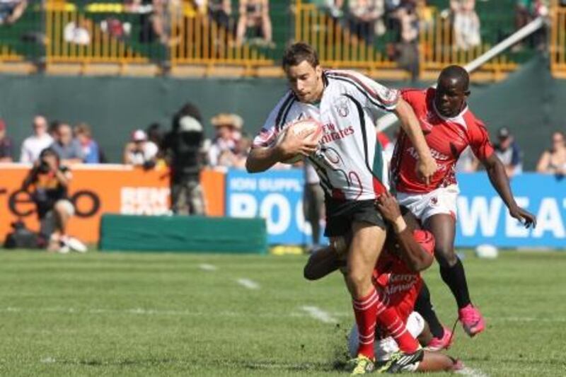 Dubai , United Arab Emirates, Dec 3 2011, UAE v Kenya , Sports Reporter Paul Radley  story- (right centre) UAE's #7 Murray Strang fights for yardage  as Kenya defenders try to pull him down  during action at the Emirates airlenes Dubai Rugby Sevens. Mike Young / The National