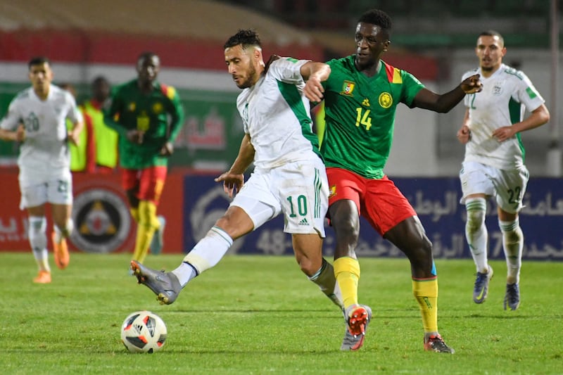 Algeria's Sofiane Feghouli is challnged by Samuel Gouet of Cameroon. AFP