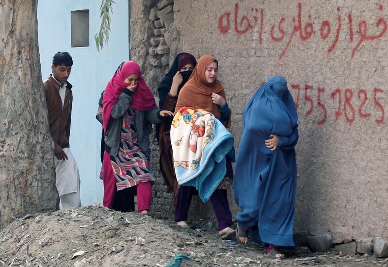 Afghan women move away from the  firefight in Jalalabad. Parwiz / Reuters