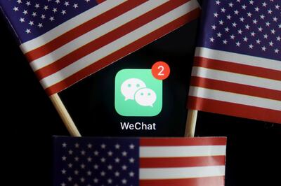 FILE PHOTO: The messenger app WeChat is seen among U.S. flags in this illustration picture taken Aug. 7, 2020. REUTERS/Florence Lo/Illustration/File Photo