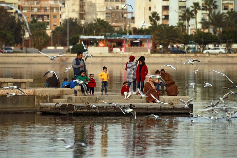 Libyans feed seagulls on the banks of the 23rd July Lake in the eastern Libyan port city of Benghazi. AFP