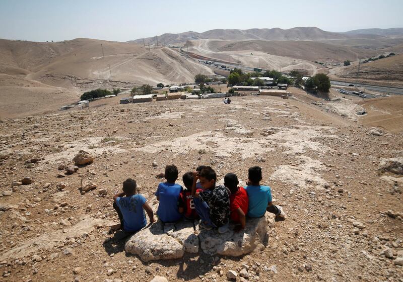 Palestinian boys sit in the Bedouin village of al-Khan al-Ahmar near Jericho in the occupied West Bank. Mohamad Torokman / Reuters