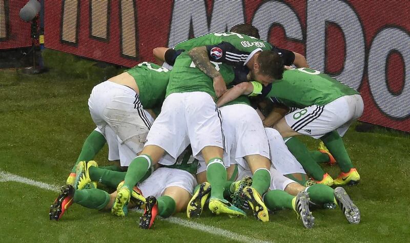 Northern Ireland players celebrate after defender Gareth McAuley gave them a 49th-minute lead courtesy of a header. Jean-Philippe Ksiazek / AFP