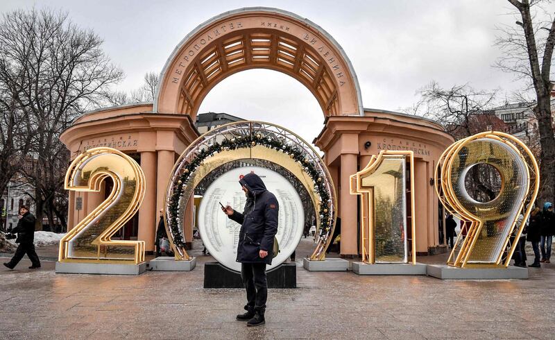 A man uses his smartphone outside the entrance to Kropotkinskaya metro station in Moscow, Russia. AFP