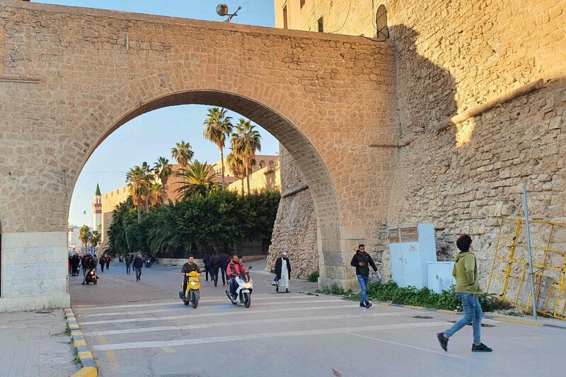 Libyans commute through an archway of the capital Tripoli's Red Castle (Al-Saraya al-Hamra).  AFP