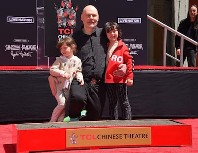 Billy Corgan poses for a photo with his family during a handprint and footprint ceremony for Smashing Pumpkins at TCL Chinese Theatre in Hollywood, California, on May 11. AFP