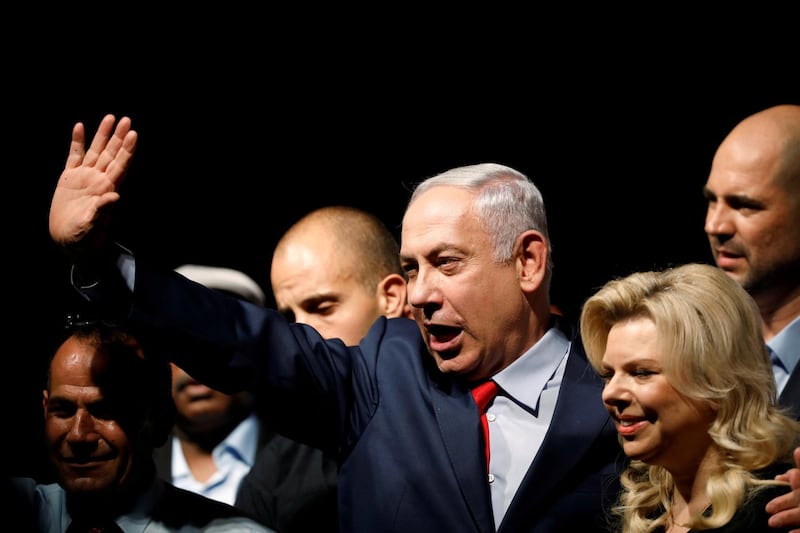 FILE PHOTO: Israeli Prime minister Benjamin Netanyahu (C) and his wife Sara react to his supporters during an event by his Likud Party, in Tel Aviv, Israel August 9, 2017. REUTERS/Amir Cohen/File Photo