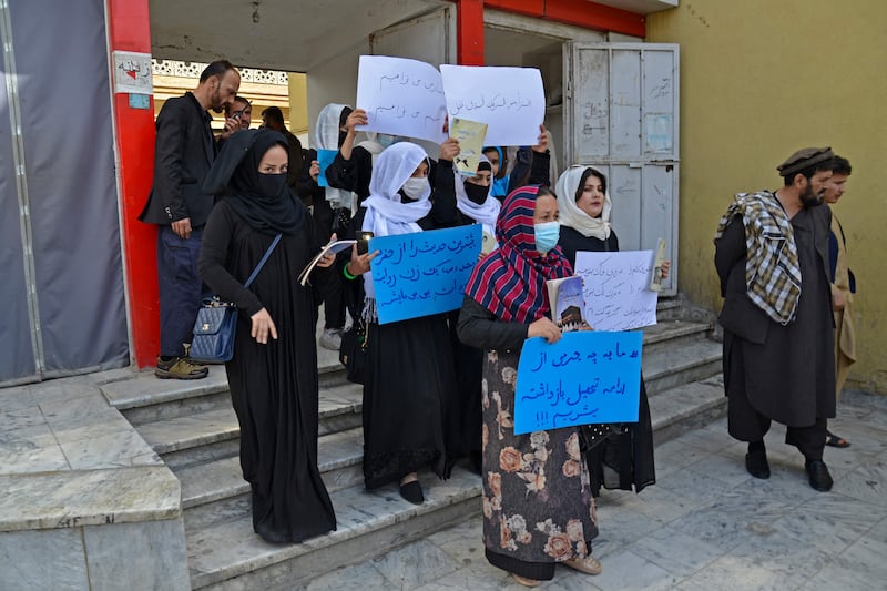 Afghan women take part in a protest in front of the Ministry of Education in Kabul demanding that high schools be reopened for girls. On Wednesday, many pupils left their schools in tears after being told there were no classes.