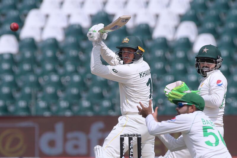 Australia's Usman Khawaja plays a shot past Pakistan's Mohammad Rizwan and Babar Azam in Lahore. AP