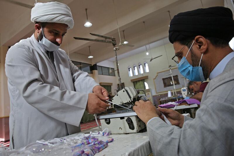 Iraqi Shiite clerics work in the Al Sadiqeen mosque in Baghdad turned into a mask production centre.  AFP