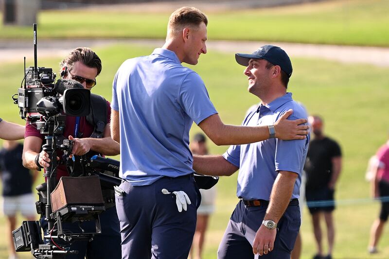 Adrian Meronk is congratulated by Continental Europe captain Francesco Molinari after sinking the putt that sealed their victory in the Hero Cup. Getty