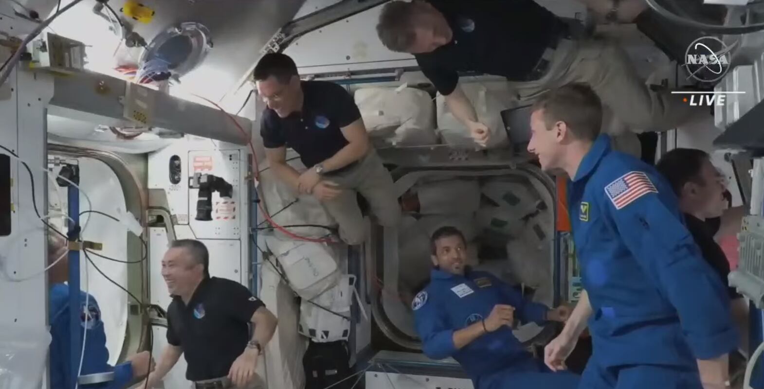 AlNedayan enters the station for the first time and greets his team mates. Photo: NASA