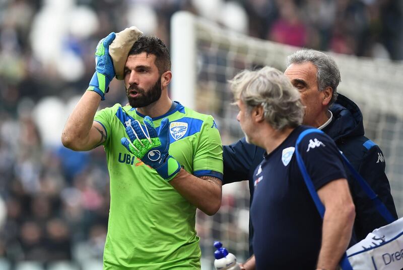 Brescia's Enrico Alfonso receives medical attention after sustaining an injury. Reuters