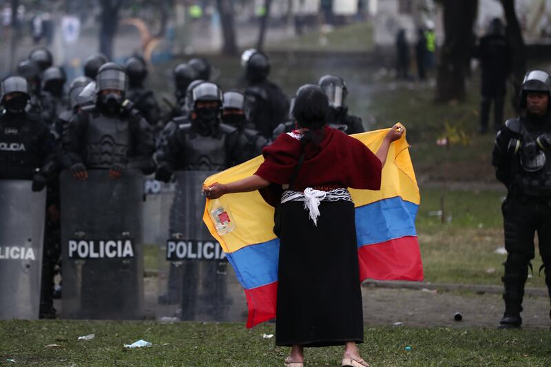 An indigenous woman waves an Ecuadorian flag while protesting against the government of Guillermo Lasso, during the 12th day of demonstrations in Quito, Ecuador. EPA