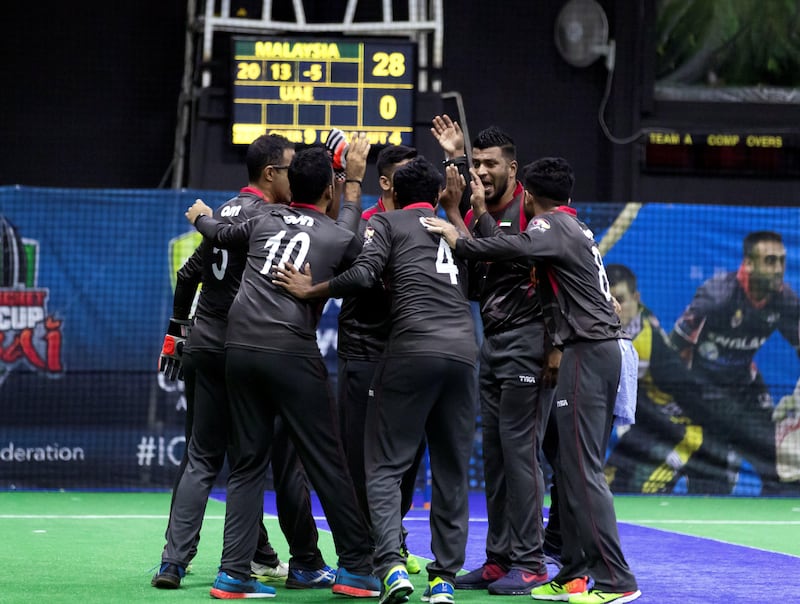 Dubai, United Arab Emirates - September 21st, 2017: UAE celebrate a wicket during the game between the UAE v Malaysia in the W.I.C.F Indoor cricket world cup 2017. Thursday, Sept 21st, 2017, Insportz, Al Quoz, Dubai. Chris Whiteoak / The National
