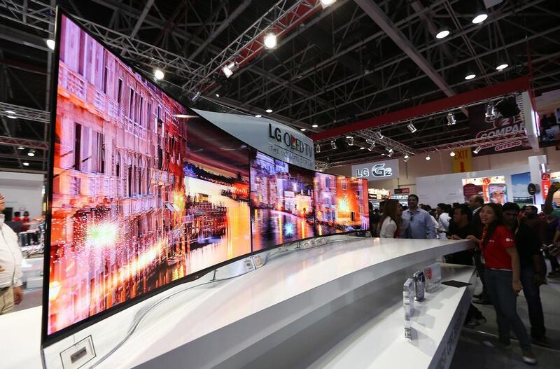 Crowds gather around the organic LED, or OLED, televisions on display, amazed by the picture quality and the concept of a curved screen.  Pawan Singh / The National