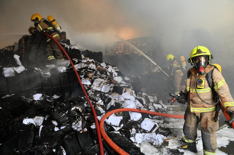 Firefighters tackle a blaze at a warehouse that stored paper and plastic materials. Courtesy: Dubai Civil Defence