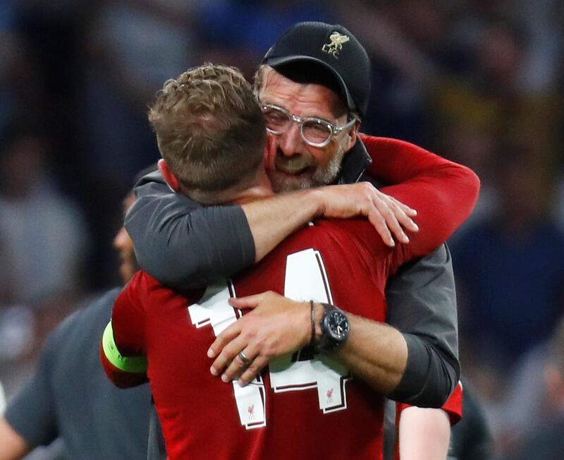 Klopp embraces his captain Jordan Henderson. Reuters