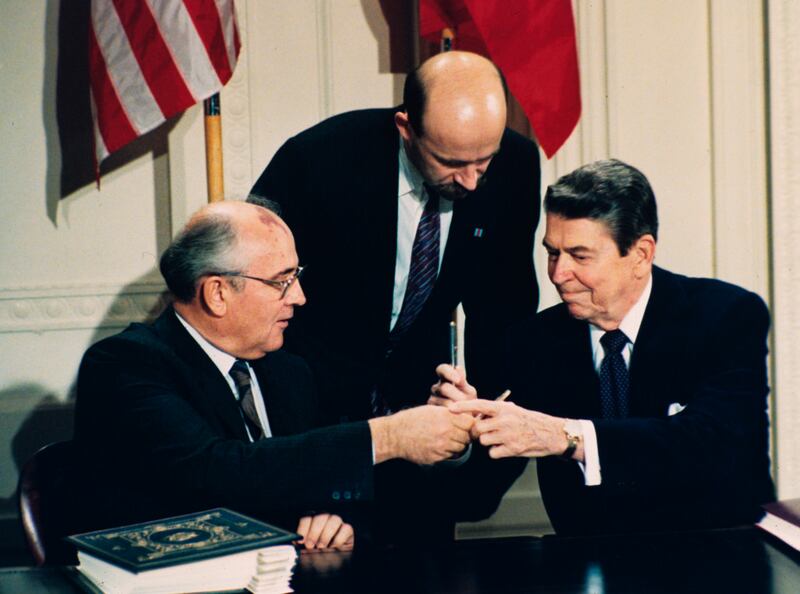 Reagan and Gorbachev exchange pens during the treaty-signing ceremony at the White House. AP