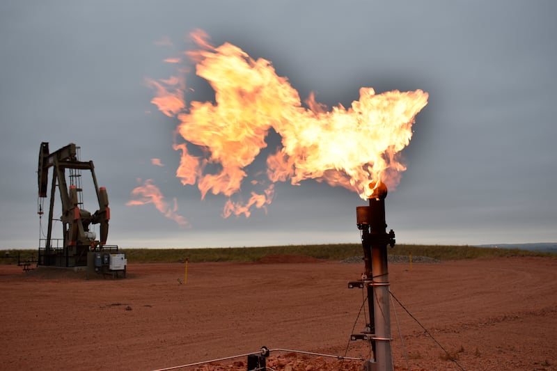 A flare burns natural gas at an oil well. AP