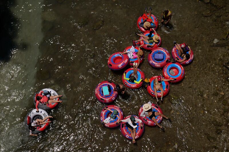 Tubers float along the Comal River in New Braunfels, Texas, as the state battles a heatwave. AP