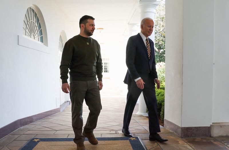 Mr Zelenskyy and Mr Biden walk the grounds of the White House. Reuters