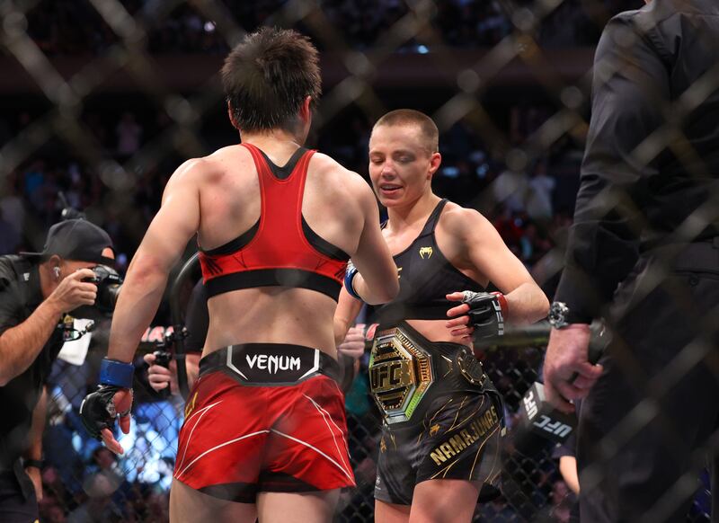 Rose Namajunas (red gloves) celebrates after defeating Zhang Weili to defender her women's UFC strawweight belt. Reuters