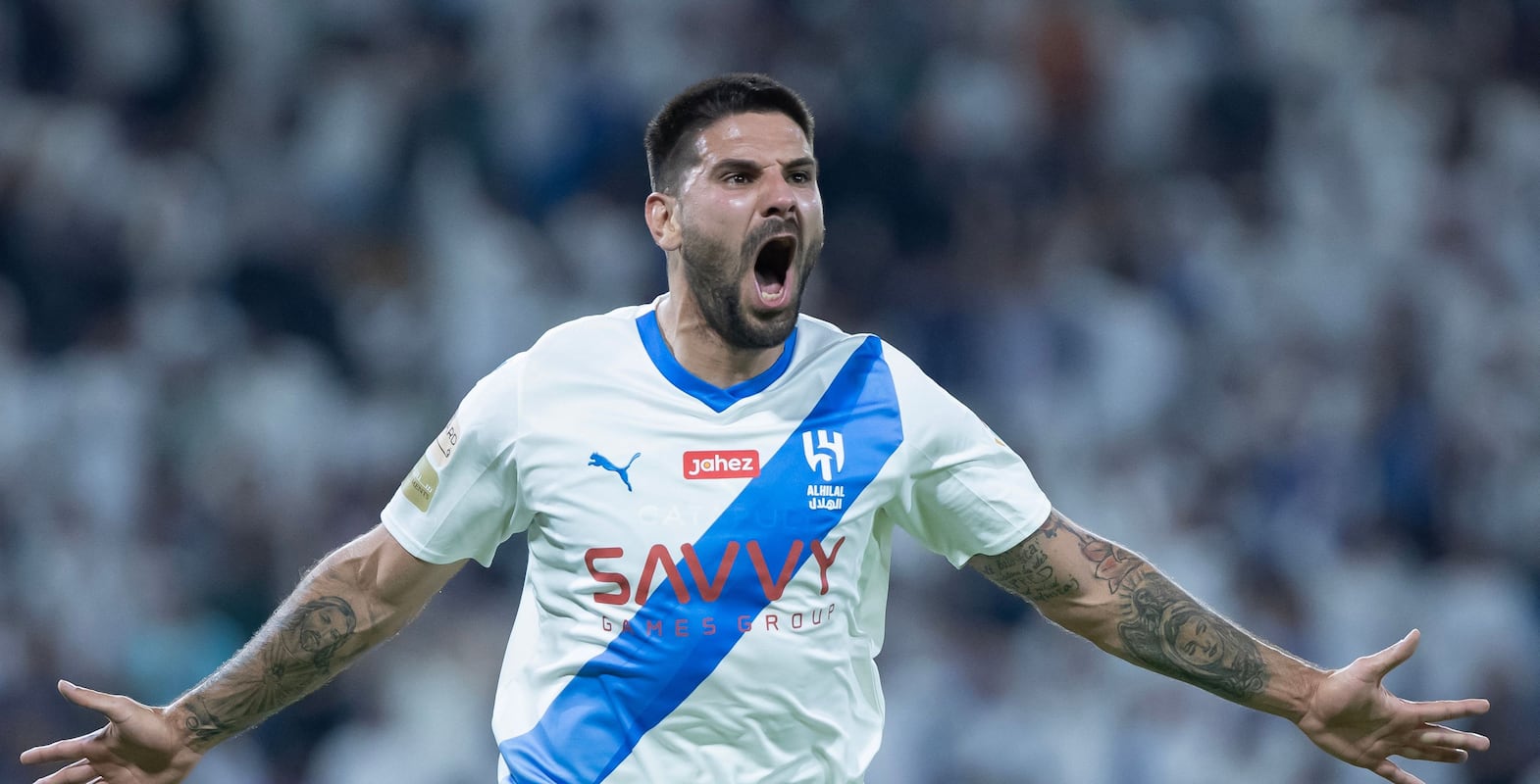 Hilal's Serbian forward #9 Aleksandar Mitrovic celebrates scoring his team's first goal during the Saudi Pro League football match between Al-Hilal and Al-Raed at the King Abdullah Stadium in Buraydah on August 24, 2023.  (Photo by AFP)
