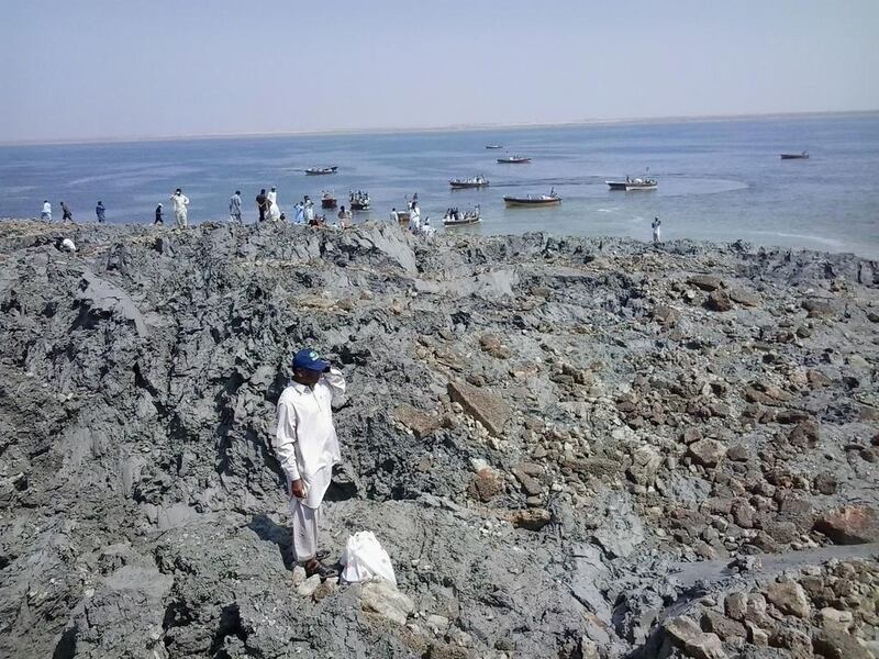 Pakistani residents gather on the island. Off the coastline near the port of Gwadar, some 400 kilometres from the epicentre, residents were astonished to see a new piece of land surface from the waves. Behram Baloch / AFP Photo
