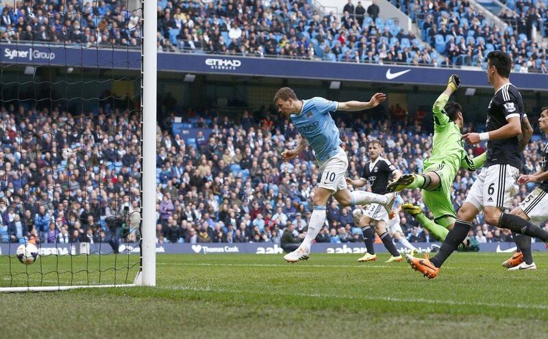Manchester City's Edin Dzeko scores his side's third goal against Southampton on Saturday. Darren Staples / Reuters / April 5, 2014