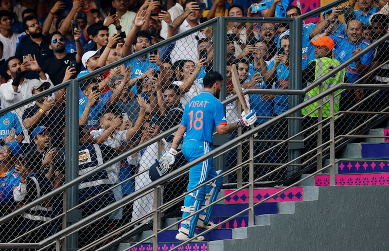Fans cheer as Virat Kohli walks back to the pavilion. Reuters