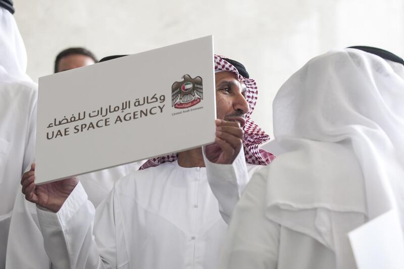 Mohamed Al Ahbabi holds up a sign as he and other guests pose after a press conference announcing The National Space Programme,. Silvia Razgova for The National