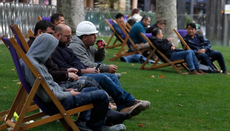 Workers sit outside a cafe during their lunch break in London. The British economy grew by far less than anticipated during August, raising concerns that the recovery from the coronavirus recession was already stuttering even before the reimposition of an array of lockdown restrictions. AP Photo