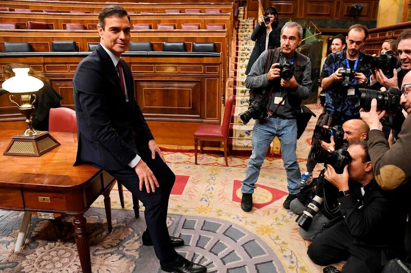 Spanish caretaker prime minister, socialist Pedro Sanchez, poses for photographers after winning a parliamentary vote to elect a premier at the Spanish Congress (Las Cortes) in Madrid on January 7, 2020. Spain's parliament today confirmed Socialist leader Pedro Sanchez by a razor-thin margin as prime minister for another term at the helm of the country's first-ever coalition government since its return to democracy in the 1970s. Sanchez, who has stayed on as a caretaker premier since inconclusive elections last year, got 167 votes in favour in the 350-seat assembly comapred to 165 against, with 18 abstentions from Catalan and Basque separatist lawmakers. / AFP / PIERRE-PHILIPPE MARCOU
