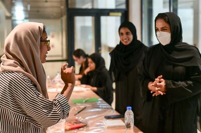 Makki, left, shares pearls of wisdom with the students. Khushnum Bhandari / The National