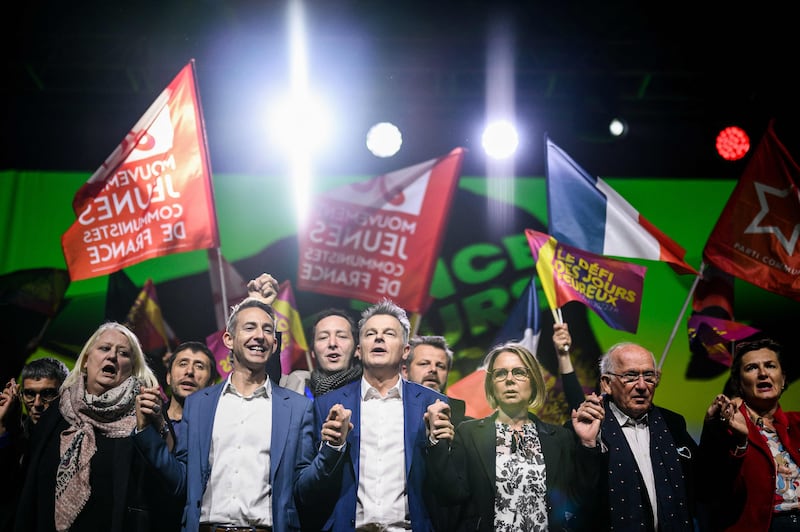 French Communist Party presidential candidate Fabien Roussel sings at the end of a campaign meeting at the Double Mixte venue in Villeurbanne. AFP