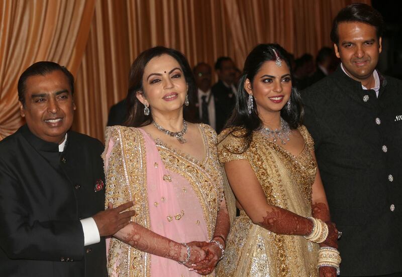 Mukesh Ambani, the Chairman of Reliance Industries, his wife Nita Ambani, their daughter Isha Ambani and her husband Anand Piramal, heir to a real-estate and pharmaceutical business, pose during Isha and Anand's wedding reception in Mumbai, India. Photo: Reuters