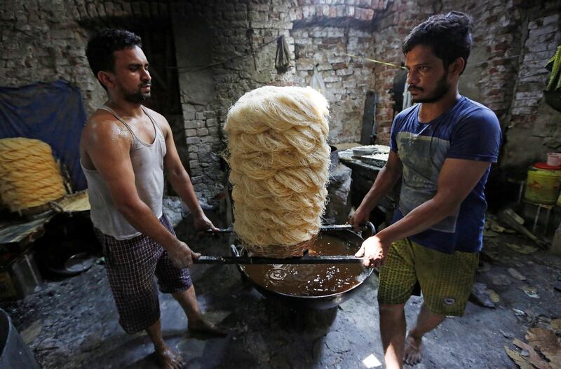Men carry vermicelli at a factory in Kolkata, India. Reuters