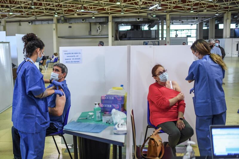 BARCELONA, SPAIN - MAY 14: People are inoculated with the Pfizer-BioNTech Covid-19 vaccine in a vaccination center in La Fira de CornellÃ  del Llobregat on May 14, 2021 in Barcelona, Spain. Spaniards under 60 were invited to receive a vaccination this week, with a target set to vaccinate 70 percent of Spain's population by the end of August.  (Photo by David Ramos/Getty Images)