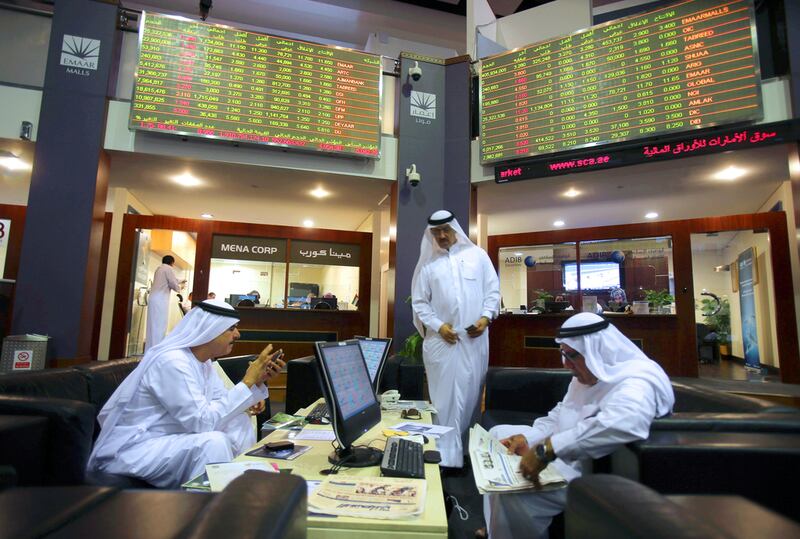 UAE stocks have been among the hardest hit among the major oil producers. Above, traders monitor market activity on the Dubai Financial Market. Kamran Jebreili / AP Photo