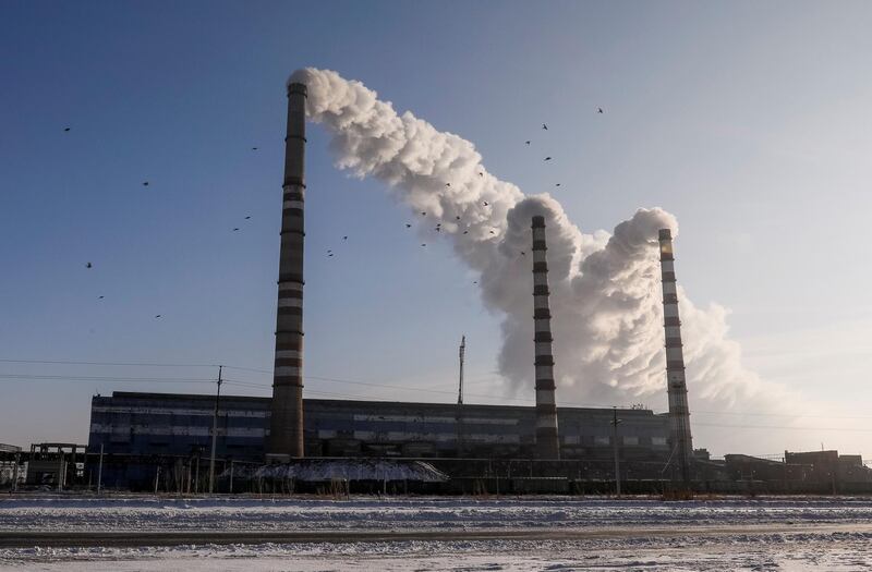FILE PHOTO: Birds fly past Eurasian Resources Group's Aksu Power Plant on the outskirts of the town of Aksu, northeastern Kazakhstan, February 22, 2018.  REUTERS/Shamil Zhumatov/File Photo